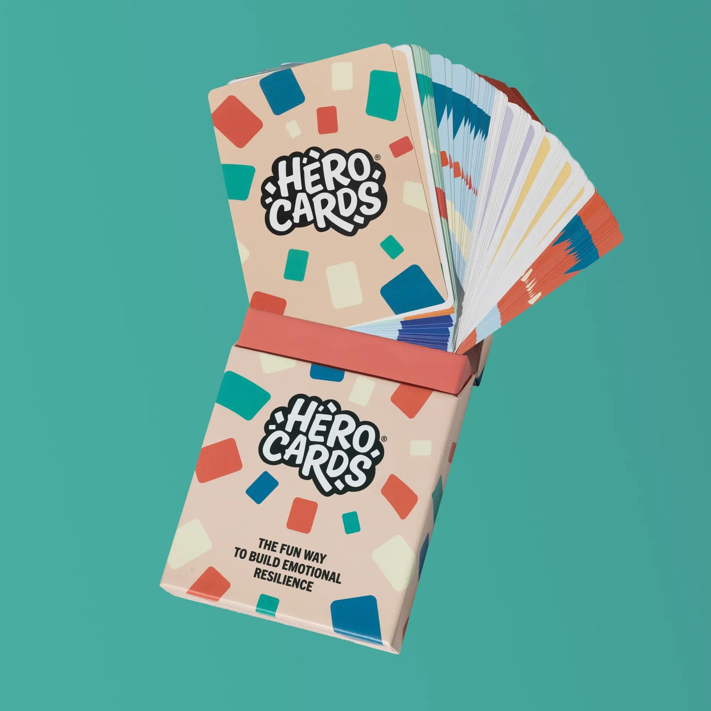 Hero Cards packaging on a teal background with cards fanning out of box